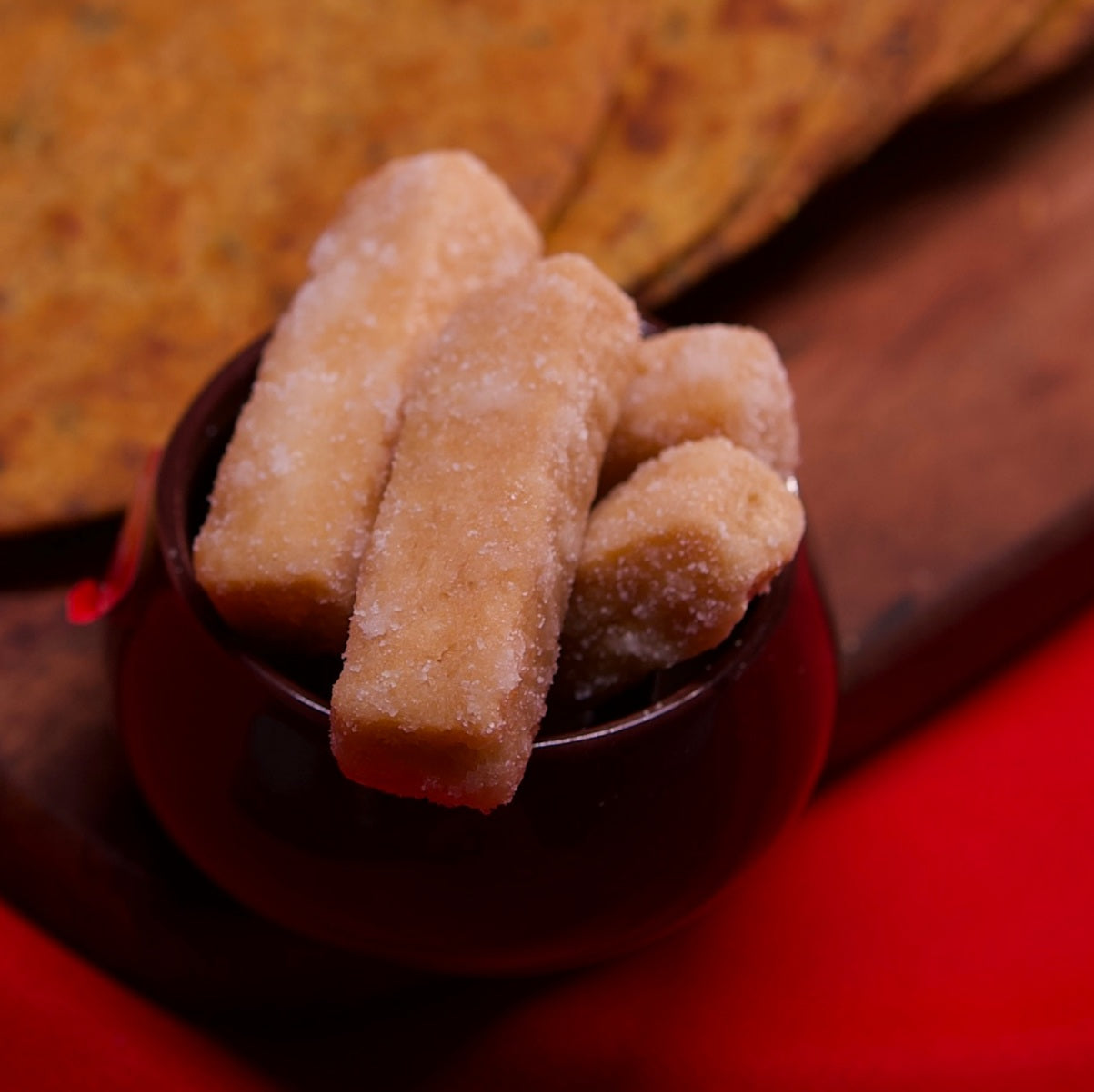 Shakarpara sweet from Bhairudan and Sons, shown in a close-up image with crispy golden-brown pieces and sweet sesame seeds.